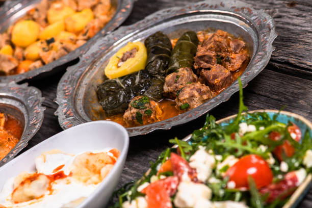 istock Eid Mubarak Traditional Ramadan Iftar dinner. Assorted tasty food in authentic rustic dishes on wooden blue background. Turkish Bosnian food meat kebab, pita, Sarma, klepe, sogan dolma. 1435638747