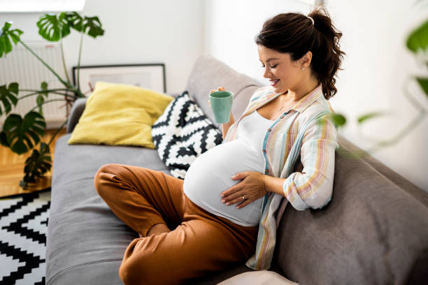 istock Pregnant woman resting on sofa 1435640761
