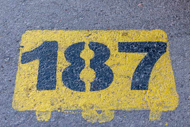 istock Number 187.  Number 187 painted yellow on asphalt. 1435640983