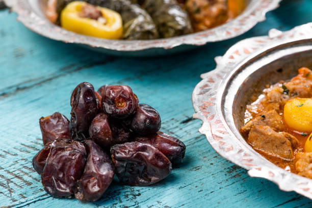 istock Eid Mubarak Traditional Ramadan Iftar dinner. Assorted tasty food in authentic rustic dishes on wooden blue background. Turkish Bosnian food meat kebab, pita, Sarma, klepe, sogan dolma. 1435642377