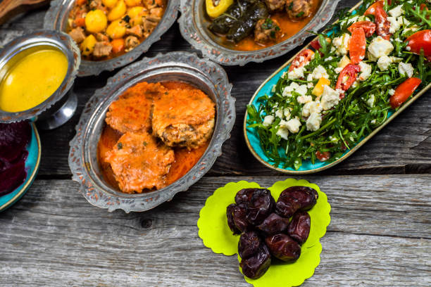 istock Eid Mubarak Traditional Ramadan Iftar dinner. Assorted tasty food in authentic rustic dishes on wooden blue background. Turkish Bosnian food meat kebab, pita, Sarma, klepe, sogan dolma. 1435642736