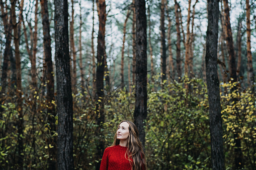Mindfulness-based cognitive therapy, Mindfulness practices. Young woman with long hair relaxing in forest.
