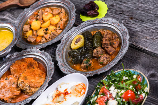 istock Eid Mubarak Traditional Ramadan Iftar dinner. Assorted tasty food in authentic rustic dishes on wooden blue background. Turkish Bosnian food meat kebab, pita, Sarma, klepe, sogan dolma. 1435644487