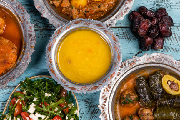 istock Eid Mubarak Traditional Ramadan Iftar dinner. Assorted tasty food in authentic rustic dishes on wooden blue background. Turkish Bosnian food meat kebab, pita, Sarma, klepe, sogan dolma. 1435644575