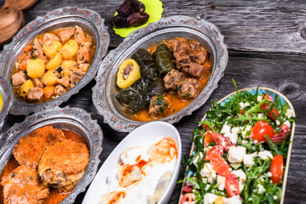 istock Eid Mubarak Traditional Ramadan Iftar dinner. Assorted tasty food in authentic rustic dishes on wooden blue background. Turkish Bosnian food meat kebab, pita, Sarma, klepe, sogan dolma. 1435644987