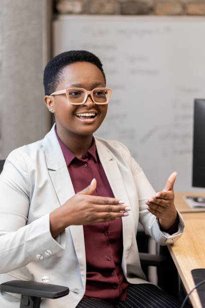 istock Ambitious young businesswoman teaching young colleagues 1435646375
