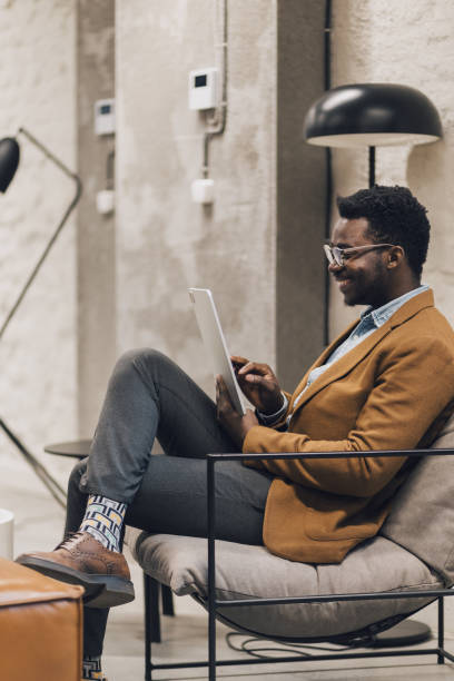 istock Modern young black businessman working on tablet 1435646754