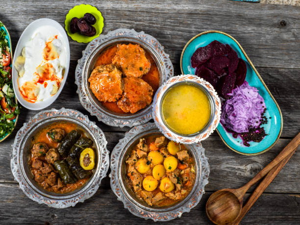 istock Eid Mubarak Traditional Ramadan Iftar dinner. Assorted tasty food in authentic rustic dishes on wooden blue background. Turkish Bosnian food meat kebab, pita, Sarma, klepe, sogan dolma. 1435650402