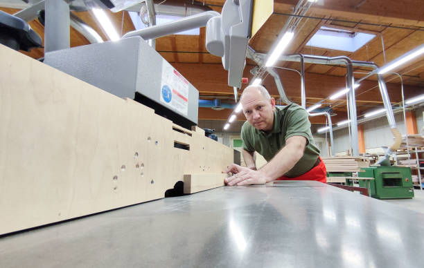 istock Caucasian man, carpenter works on a milling woodworking machine. 1435653415