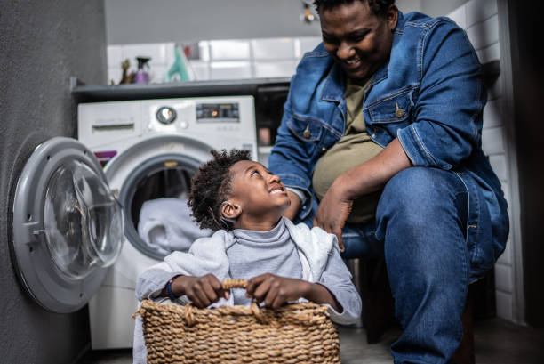 istock Father and son playing on a basket in the laundry at home 1435654805
