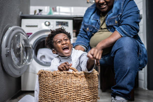 istock Father and son flying on a basket in the laundry at home 1435654828