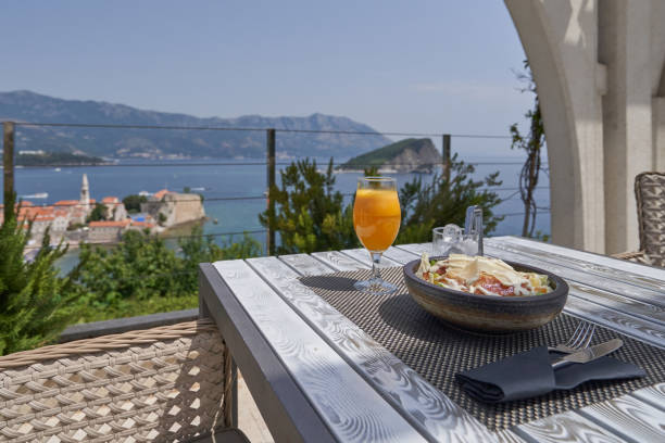 istock Breakfast and fresh juice on the table in a restaurant with sea view 1435655045