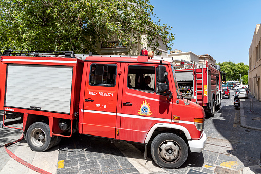 Firefighter protection gear, helmet, gloves on the bumper of the fire truck