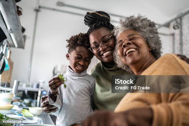 Happy Family Cooking At Home Stock Photo - Download Image Now - Family, Multi-Generation Family, Mother