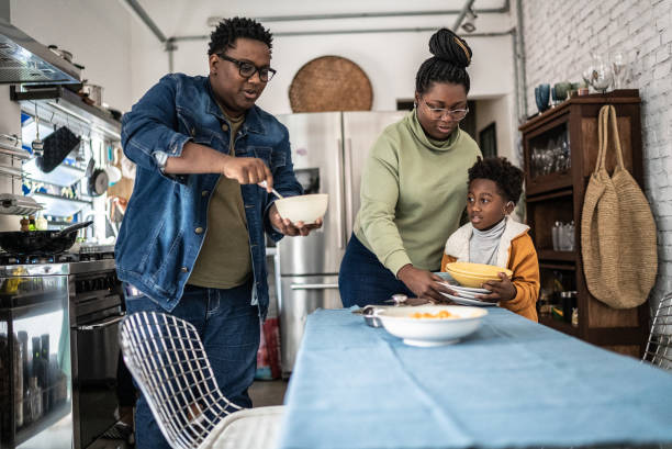 istock Family setting the table and preparing the lunch at home 1435656573