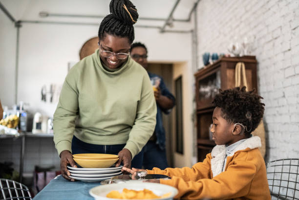 istock Mother and son setting the table and preparing the lunch at home 1435656591