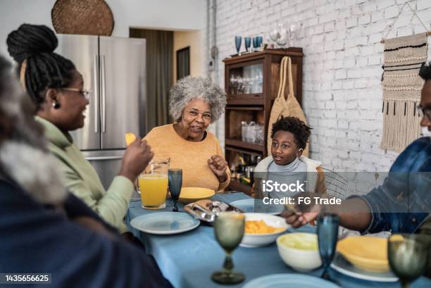 Family Talking And Eating During The Lunch At Home Stock Photo - Download Image Now - Eating, People, Dinner