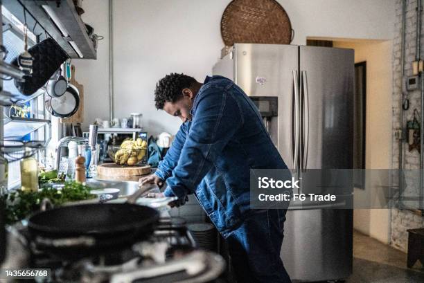 Sad Mid Adult Man In The Kitchen At Home Stock Photo - Download Image Now - Tired, Post-traumatic stress disorder, Exhaustion