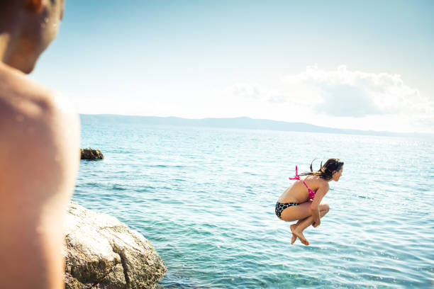 istock Young man having fun and taking a dive in the sea 1435656831
