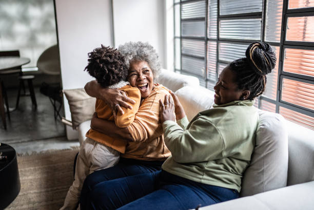 Child playing with his mother and grandmother in the living room at home