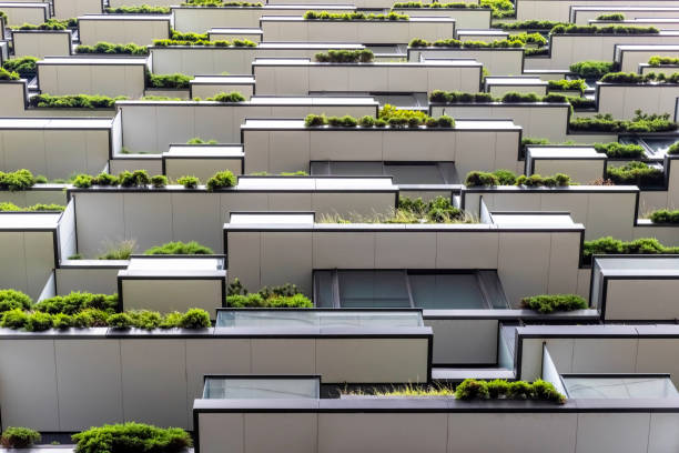 Closeup low angle view of apartment building with vertical gardens, background with copy space, full frame horizontal composition