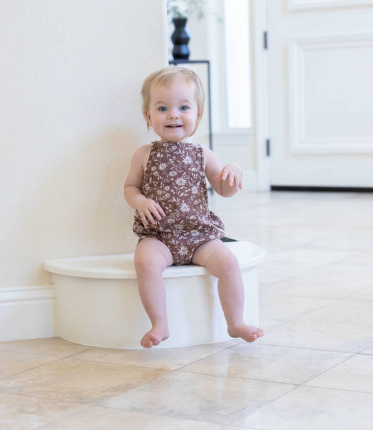 istock Cute Little Female Toddler Smiling While Sitting on Step 1435658218