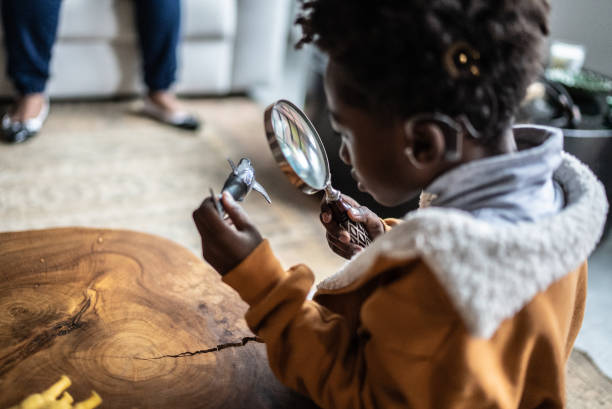 istock Child looking a toy with a loupe at home 1435658711