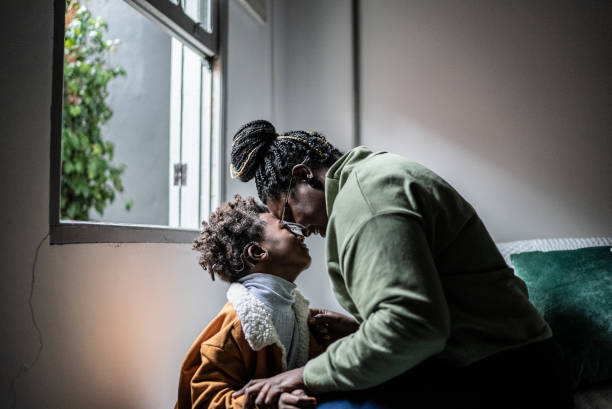 istock Mother and son touching their heads at home 1435658794