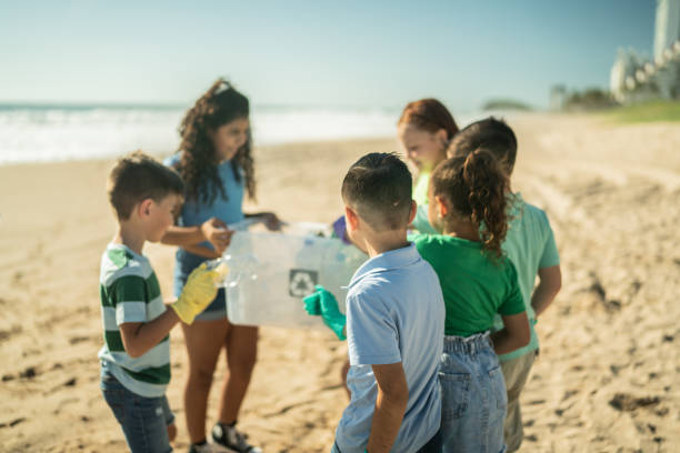 istock Children collecting garbage at the beach 1435661752
