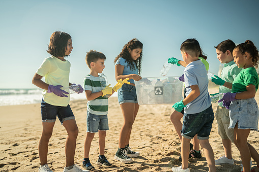Children collecting garbage at the beach
