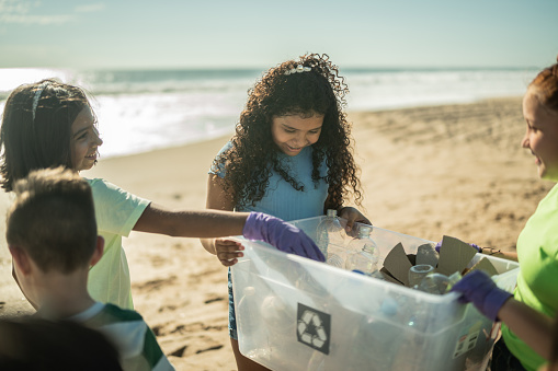 istock Children collecting garbage at the beach 1435661758