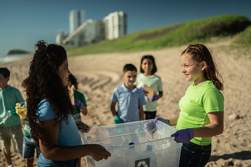 Children collecting garbage at the beach