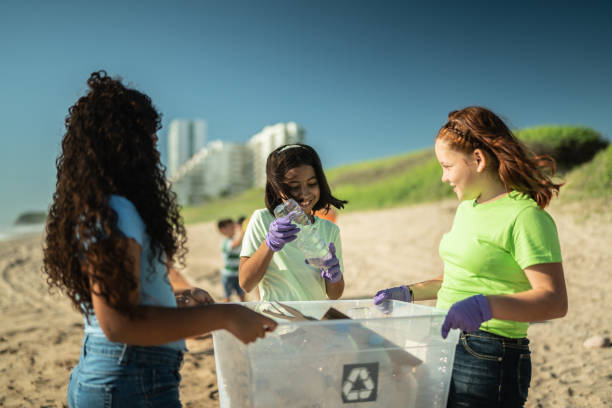 istock Girls collecting garbage at the beach 1435661781