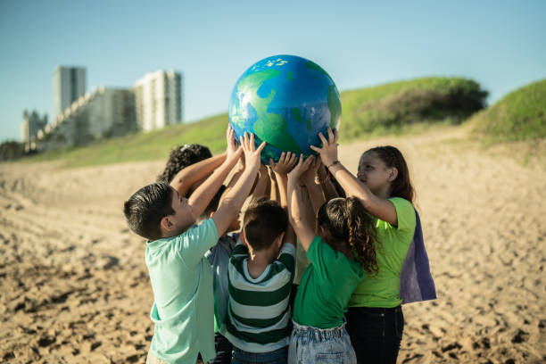 istock Children holding a planet at the beach 1435661956