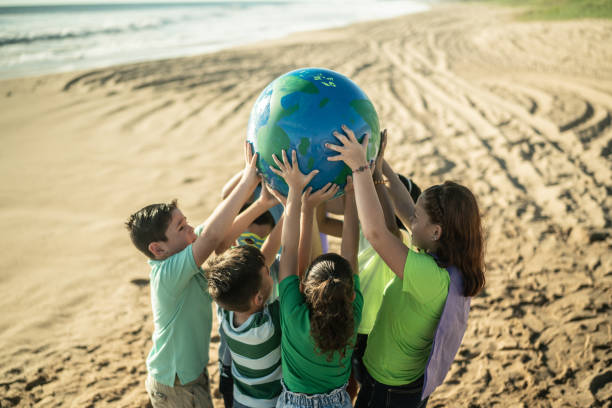 istock Children holding a planet at the beach 1435661962