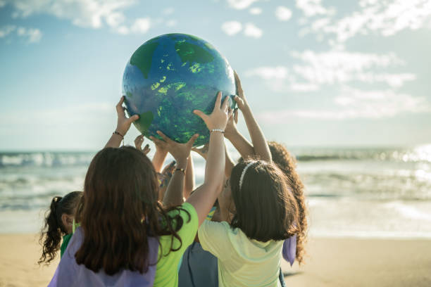 istock Children holding a planet at the beach 1435661966