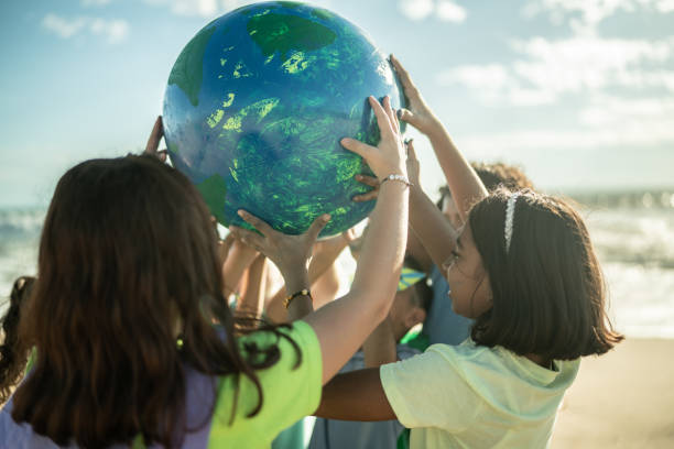 istock Children holding a planet at the beach 1435661968