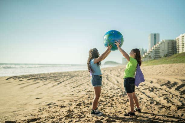 istock Girls holding a planet at the beach 1435661977