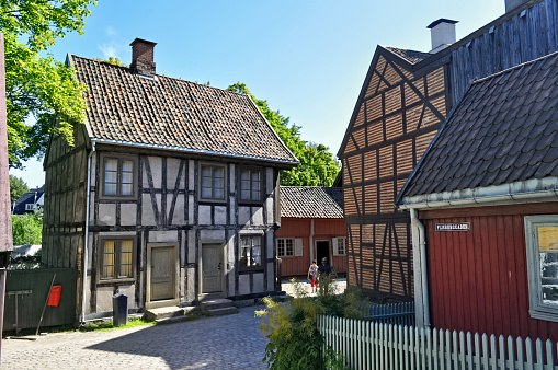 Oslo, Norway - July 17, 2021: Old wooden and brick buildings on Bygdoy peninsula. Norwegian open-air museum in Oslo.