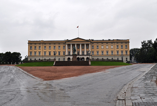 Oslo, Norway - July 17, 2021: The Royal Palace, the residence of the royal family in the center of the city with a park for rain and bad weather.