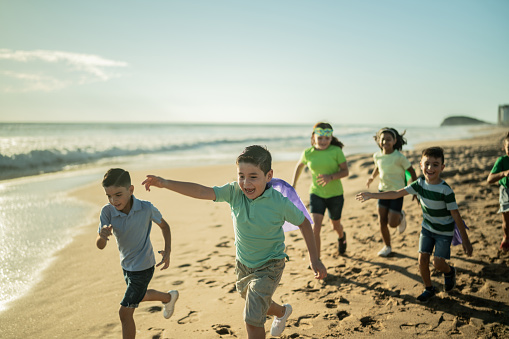 Group of children running at the beach