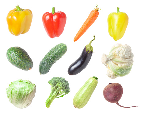 Set of ripe vegetables on a white background - lettuce, broccoli, cucumber, carrot, avocado, bell pepper and beetroot on a white background close-up