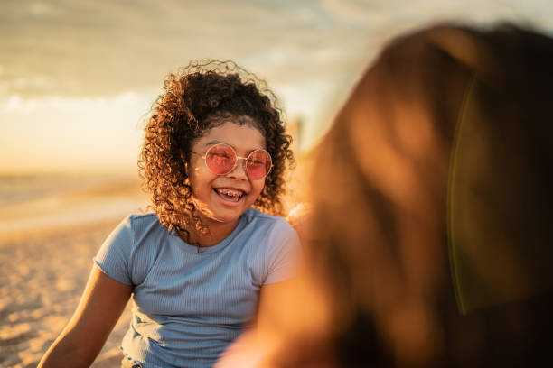 istock Girls talking at sunset on the beach 1435663303