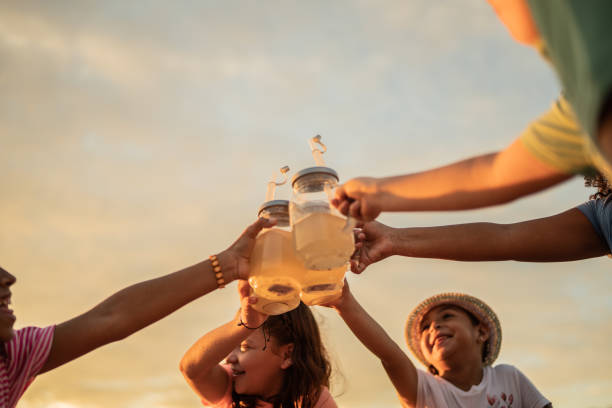 Children toasting while having a picnic at the beach