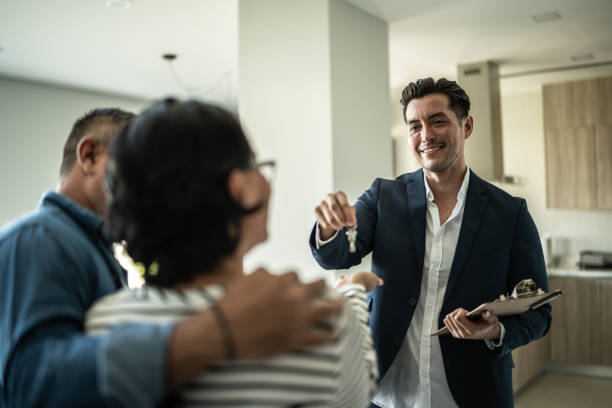 Mortgage broker giving the house key to a client