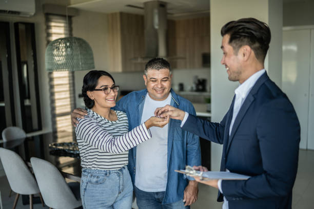 Real estate agent giving the home keys to a customer stock photo