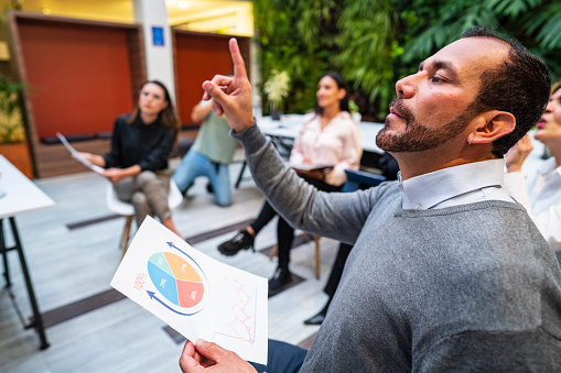 Employees of different ages and races participate in the company speech