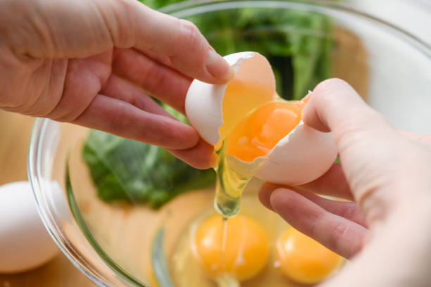 istock Chicken egg is broken and placed in a glass bowl 1435666760