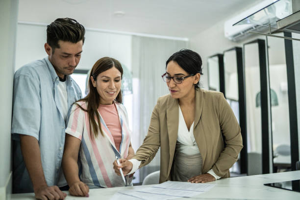 istock Mid adult couple signing documents at home 1435667166