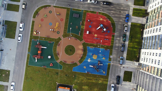 Aerial view of the new children playground at modern complex of apartment residential buildings. Modern developing infrastructure